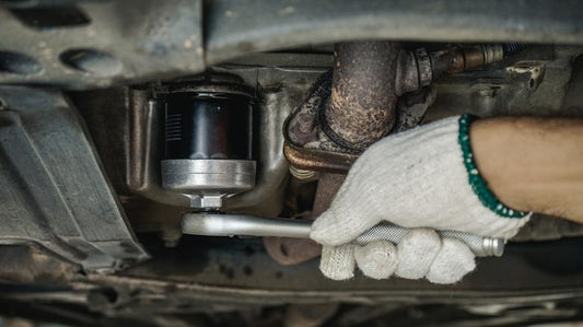 Adjustable oil filter wrench removing a stuck oil filter